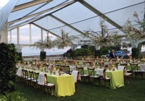 A clear tent with hanging chandeliers